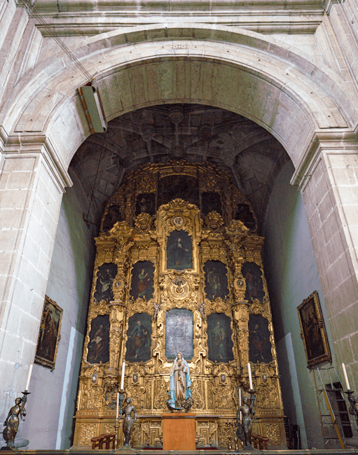 Ornate golden altar inside a Spanish church