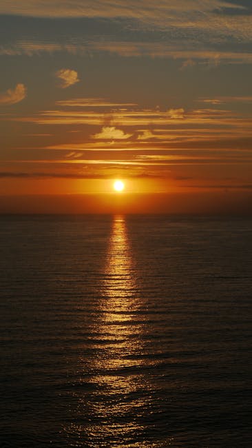Orange sunset reflecting over calm sea water