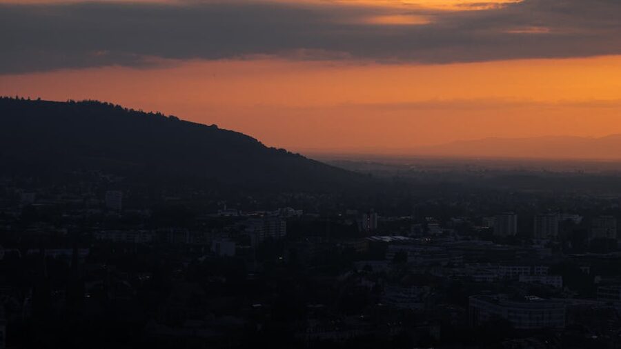 Golden sunset view from hills over a city