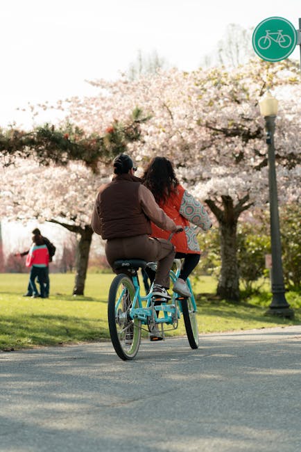 Tandem bicycle with two riders in an urban setting