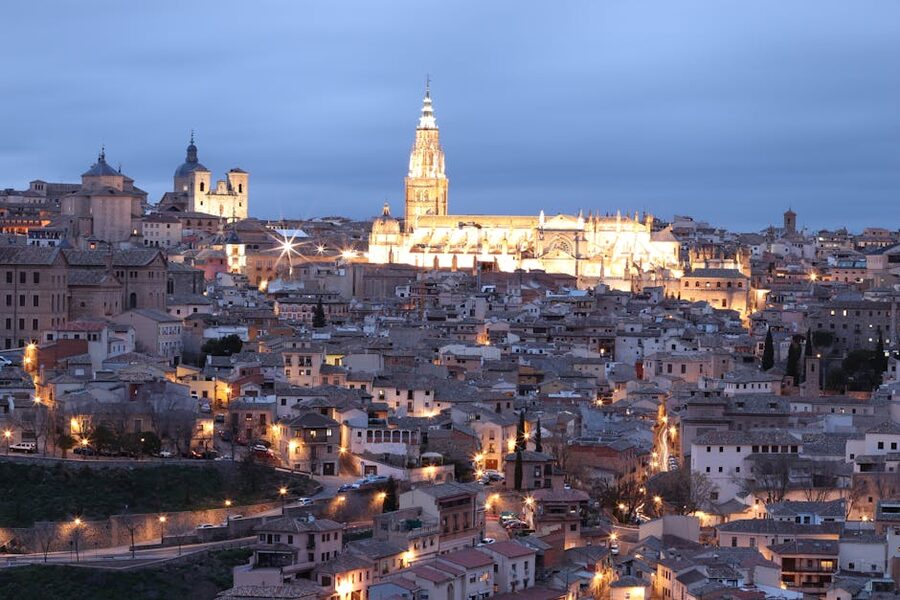 Toledo skyline illuminated at night with lights reflecting on river