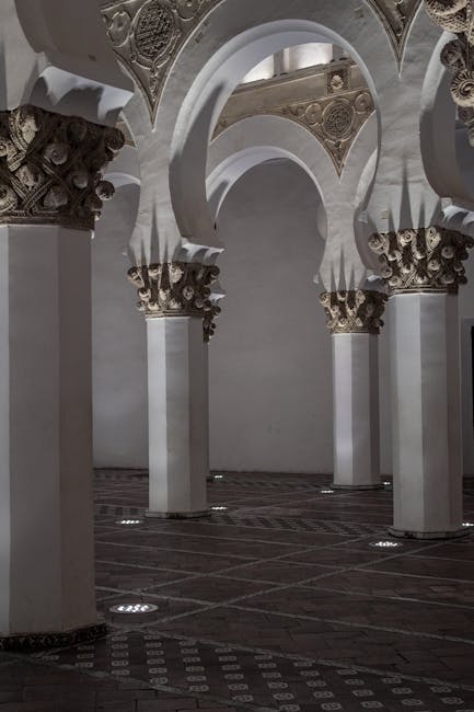 White Moorish arches inside a historic synagogue in Toledo