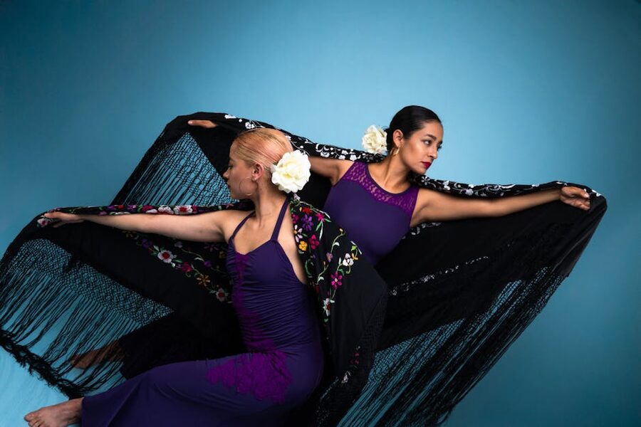 Two flamenco dancers in purple dresses