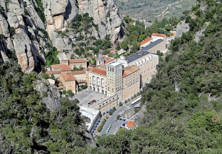 Exterior view of the Abbey of Montserrat against mountain rocks