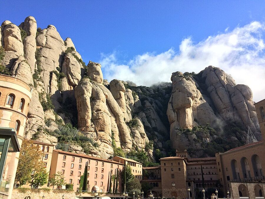 Courtyard and buildings of Montserrat monastery with mountain behind