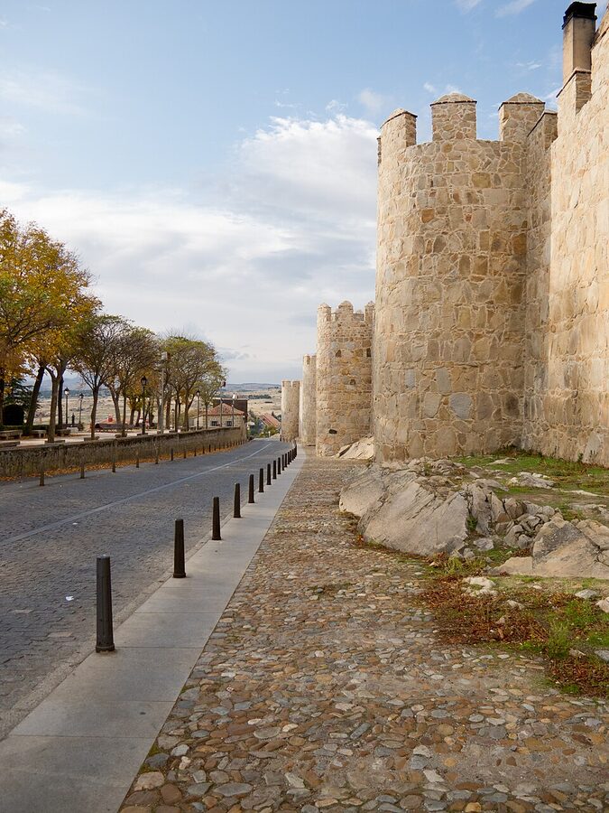 Complete medieval walls of Avila with towers stretching into distance
